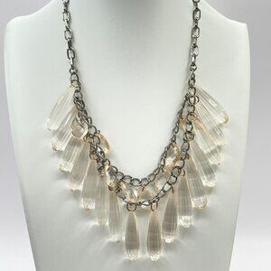Clear plastic beads with a very slight pink tint on a gunmetal chain.